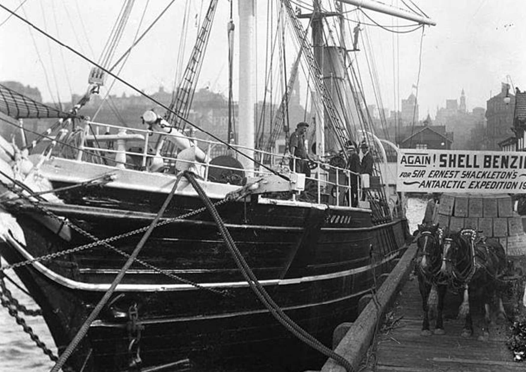Black and white photograph of a sailing ship in port
